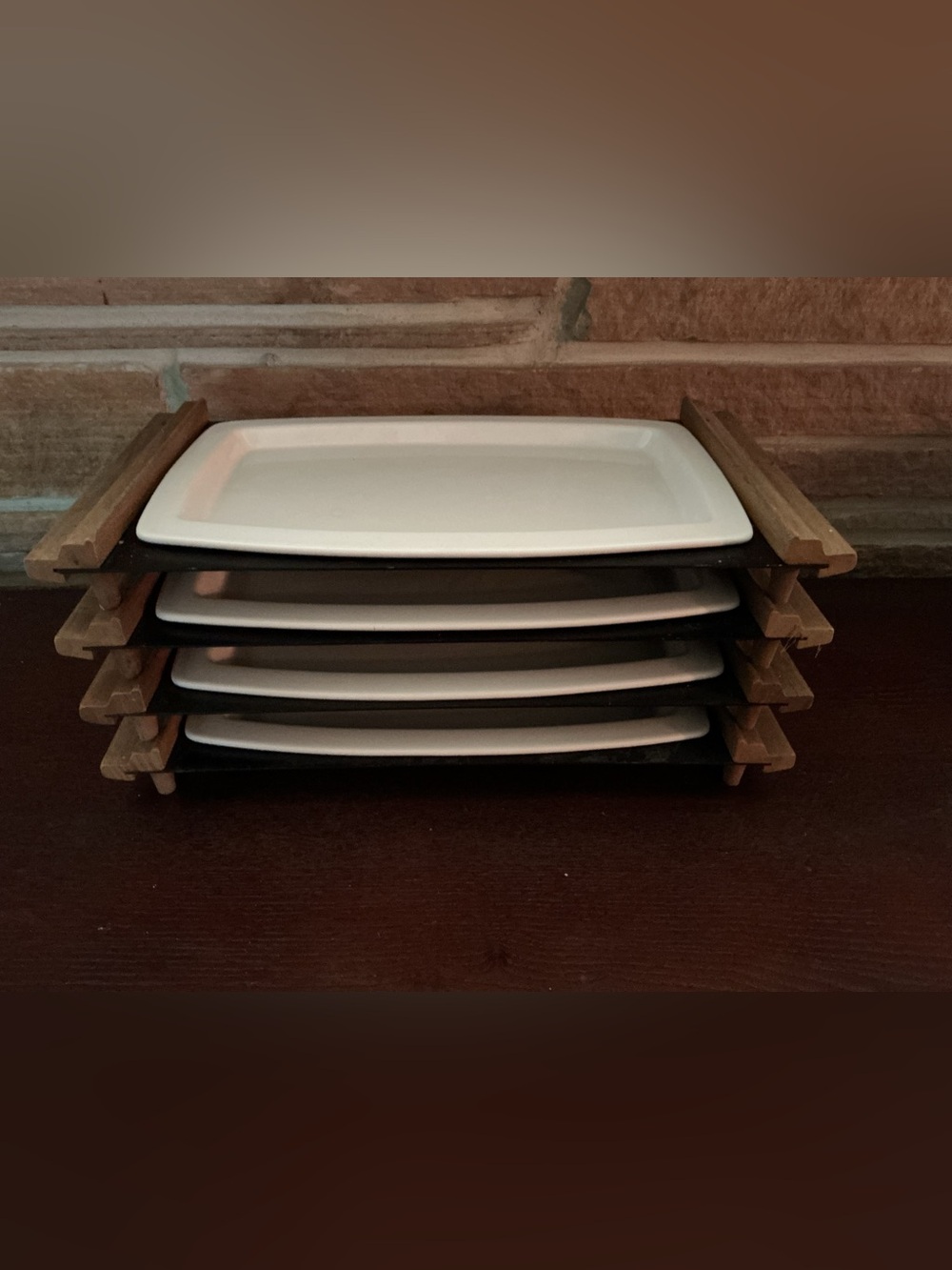 Vintage Cutco steak sizzler plates in tiered metal rack